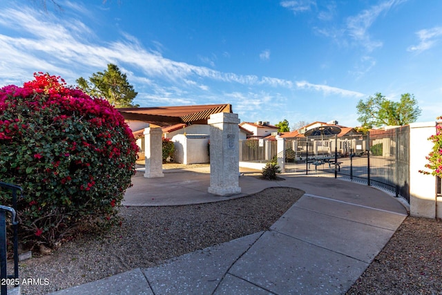 exterior space with a patio area, a gate, and fence