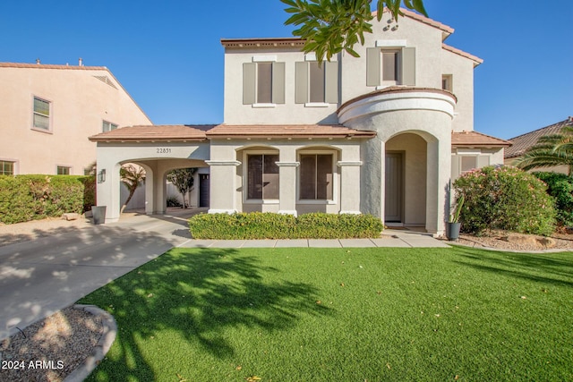 mediterranean / spanish-style home with a front lawn