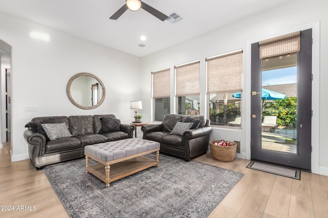 living room with ceiling fan and light wood-type flooring