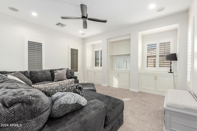 living room featuring light colored carpet and ceiling fan