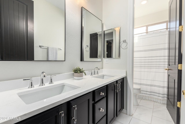 bathroom featuring tile patterned floors, vanity, and toilet