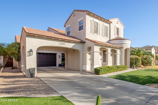 mediterranean / spanish home featuring a garage