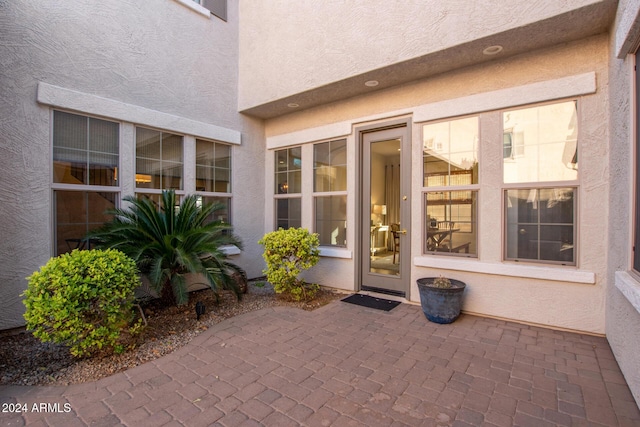 property entrance featuring a patio area