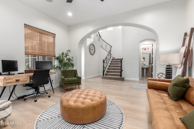 home office featuring ceiling fan and light hardwood / wood-style floors