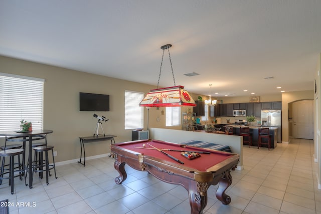 recreation room featuring a notable chandelier, pool table, and light tile patterned floors