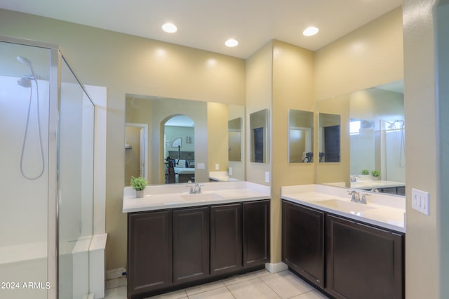 bathroom featuring tile patterned floors, a shower, and vanity