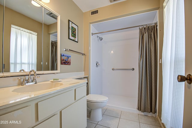 bathroom featuring tile patterned flooring, toilet, a shower with shower curtain, vanity, and visible vents