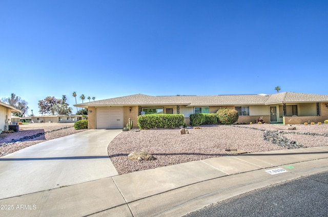 ranch-style home with brick siding, driveway, and an attached garage