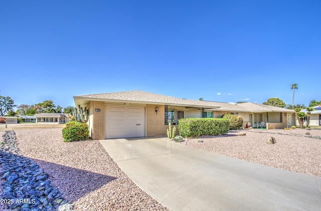 ranch-style home with brick siding, driveway, and an attached garage