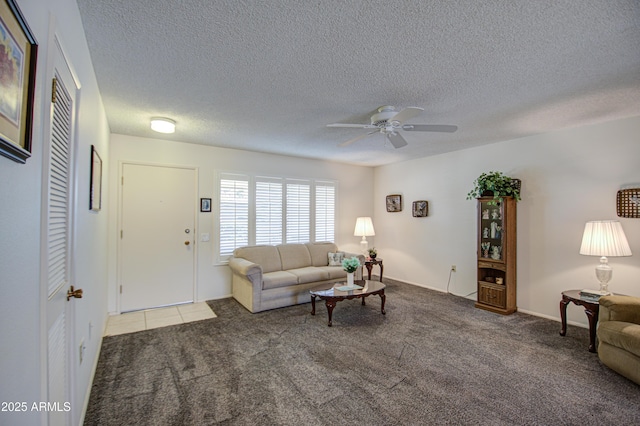 living room with a textured ceiling, carpet floors, and a ceiling fan