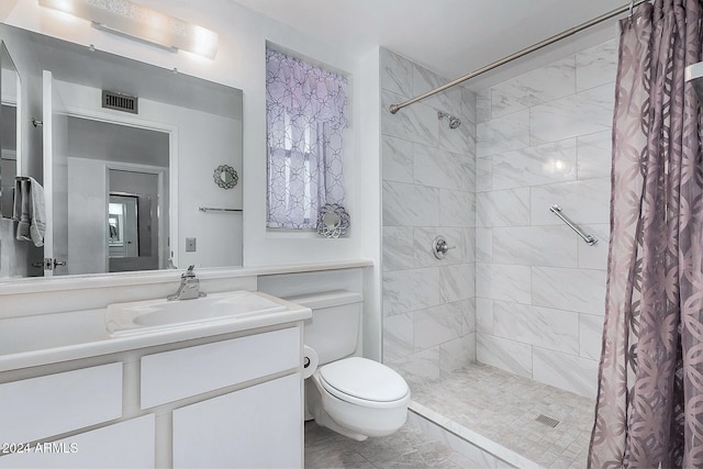 bathroom featuring walk in shower, vanity, and toilet