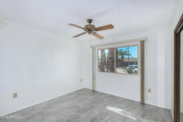 unfurnished room with a textured ceiling and ceiling fan