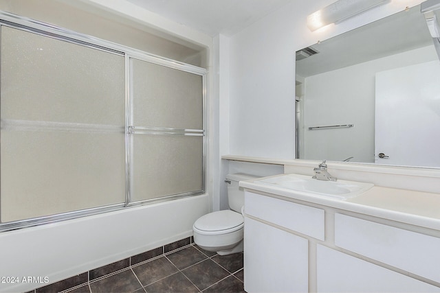 full bathroom featuring vanity, tile patterned floors, toilet, and combined bath / shower with glass door