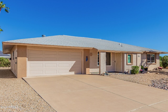 ranch-style home featuring a garage