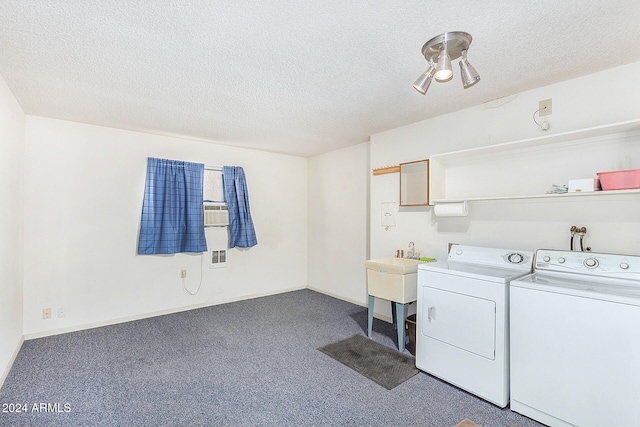 laundry area featuring a textured ceiling, washer and clothes dryer, and carpet floors