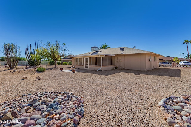 rear view of house featuring a patio and a sunroom