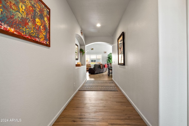 hall with hardwood / wood-style flooring