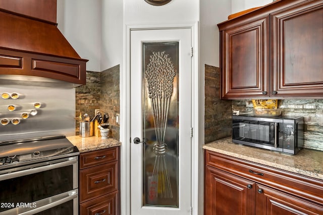 kitchen featuring backsplash, light stone countertops, and stainless steel appliances