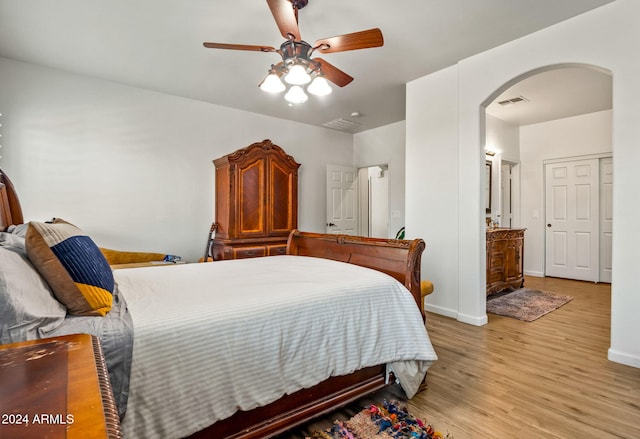 bedroom with light hardwood / wood-style flooring and ceiling fan