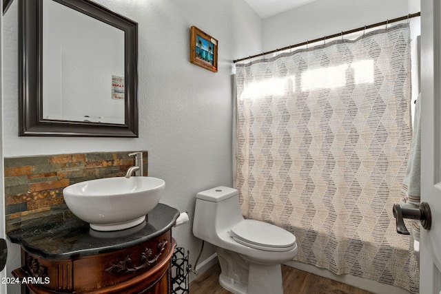 full bathroom featuring vanity, hardwood / wood-style flooring, toilet, and shower / bathtub combination with curtain