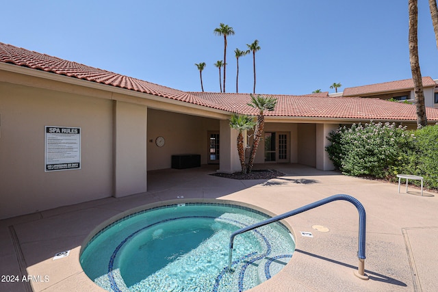 view of swimming pool with a community hot tub and a patio