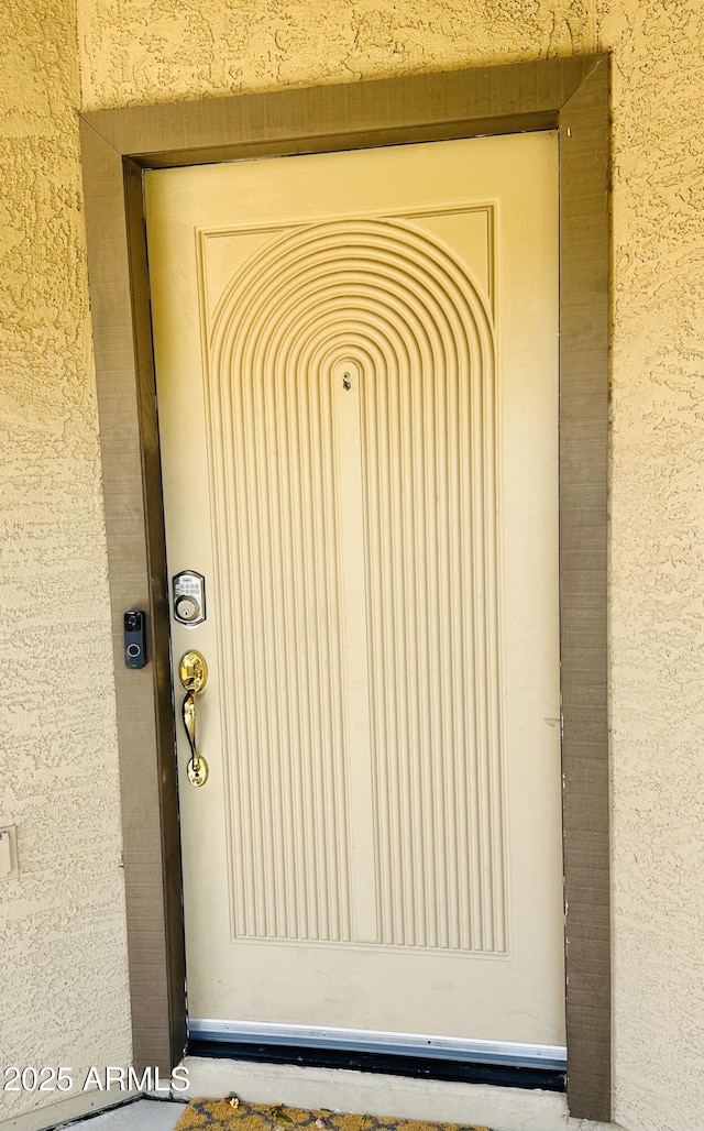 doorway to property with stucco siding