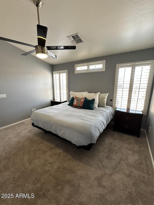 carpeted bedroom with baseboards and ceiling fan