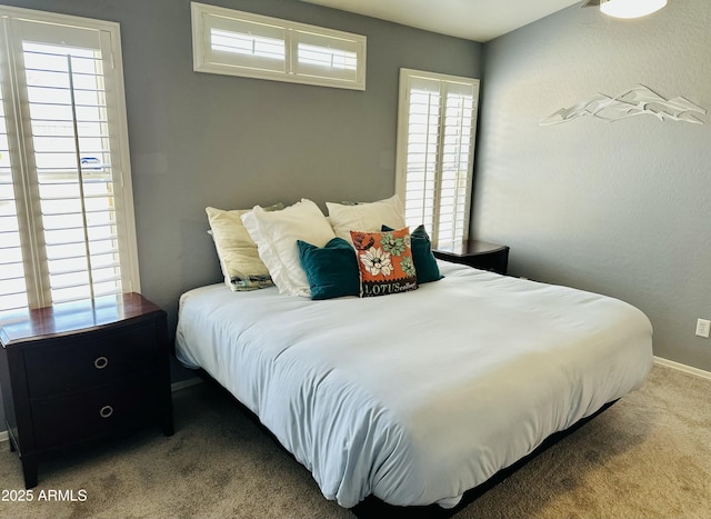 bedroom featuring carpet and baseboards