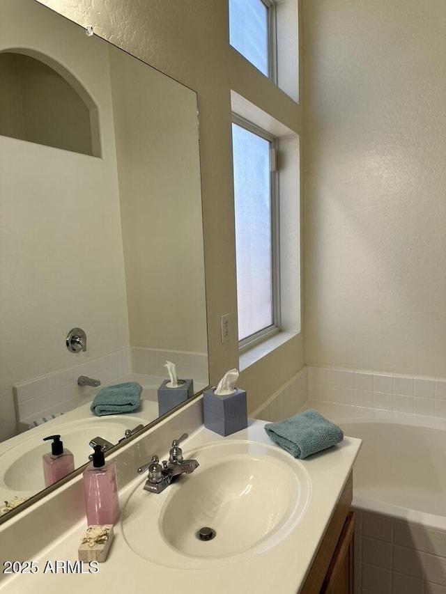 full bathroom with vanity and a garden tub