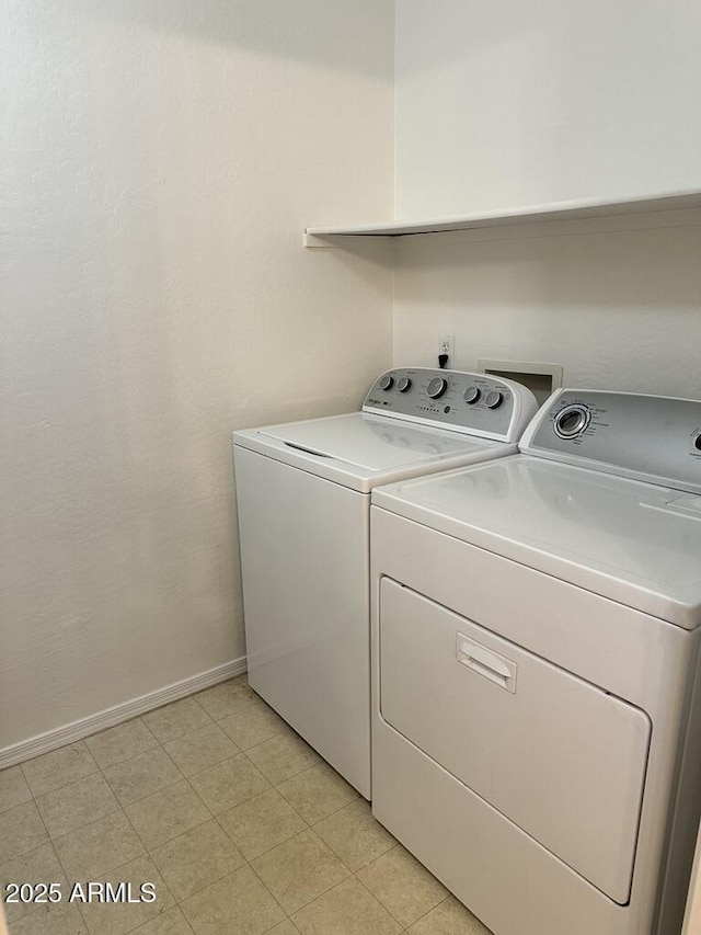 laundry area featuring separate washer and dryer and baseboards