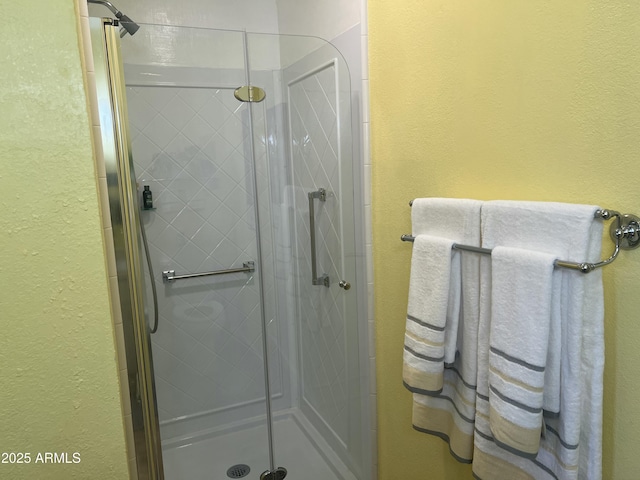 9679 W Cinnabar Ave Unit B, Peoria, AZ 85345 - full bathroom featuring a stall shower and a textured wall