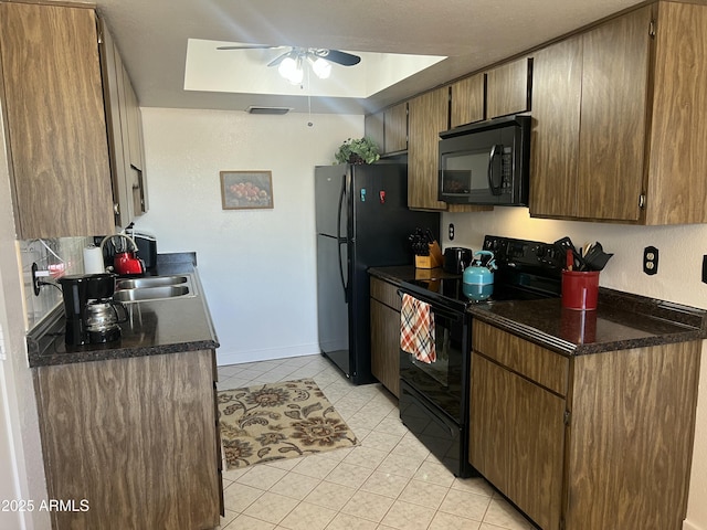 9679 W Cinnabar Ave Unit B, Peoria, AZ 85345 - kitchen with light tile patterned floors, a ceiling fan, a sink, dark countertops, and black appliances