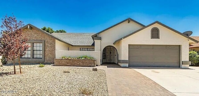 6601 W Montego Ln, Glendale, AZ 85306 - view of front of home with an attached garage, concrete driveway, and stucco siding