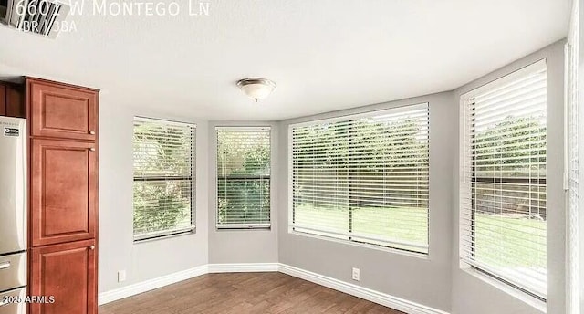 6601 W Montego Ln, Glendale, AZ 85306 - unfurnished dining area with wood finished floors and baseboards