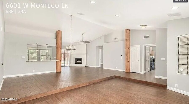 6601 W Montego Ln, Glendale, AZ 85306 - unfurnished living room featuring washing machine and clothes dryer, hardwood / wood-style flooring, baseboards, a chandelier, and a ceiling fan