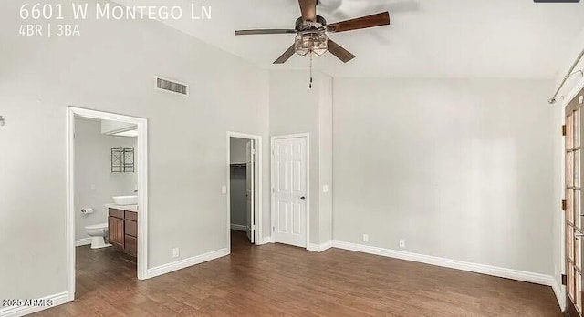 6601 W Montego Ln, Glendale, AZ 85306 - unfurnished bedroom featuring dark wood-type flooring, baseboards, ensuite bathroom, high vaulted ceiling, and a closet
