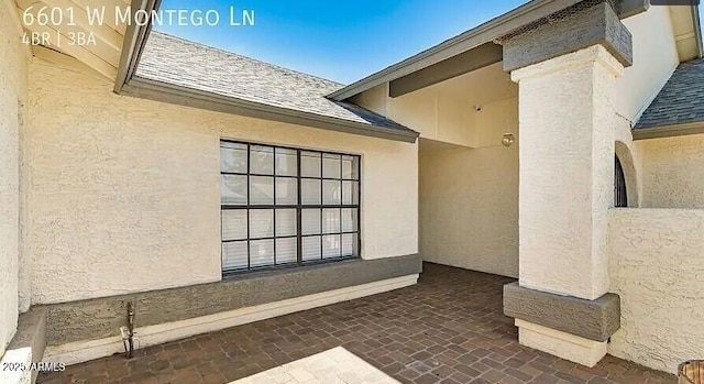 6601 W Montego Ln, Glendale, AZ 85306 - view of side of home featuring roof with shingles and stucco siding
