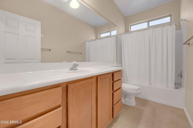 full bathroom with vanity, toilet, tile patterned flooring, and shower / bath combo with shower curtain