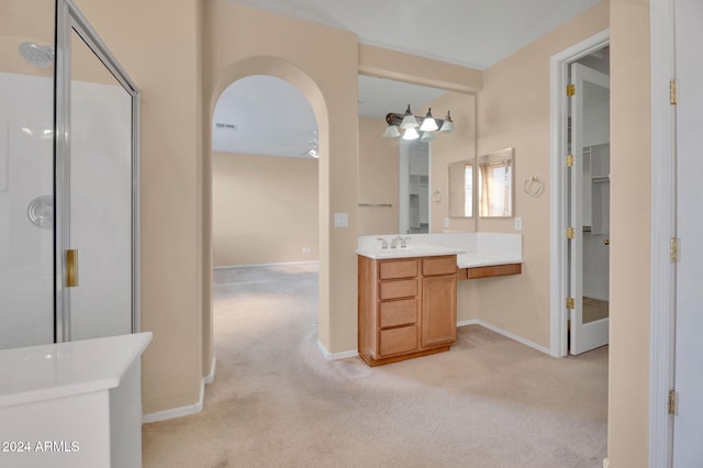 bathroom featuring vanity and an enclosed shower