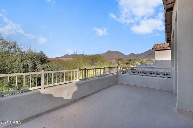 view of patio with a balcony and a mountain view