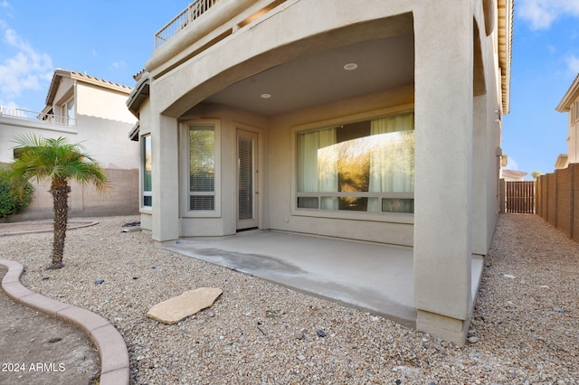 view of exterior entry featuring a patio