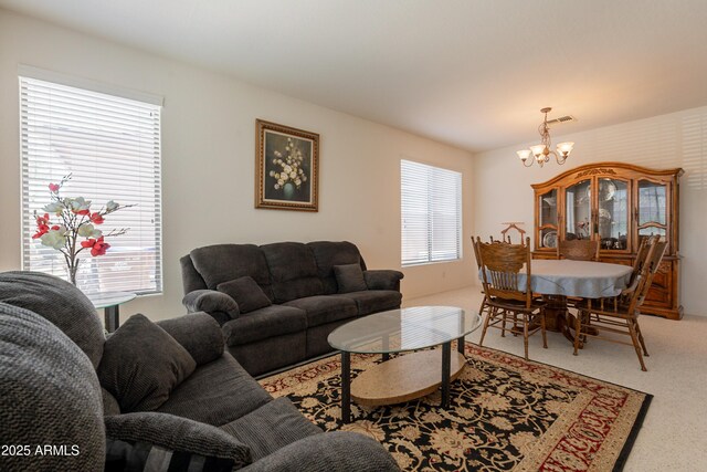 170 E Canary Ct, San Tan Valley, AZ 85143 - living area with a chandelier, light colored carpet, and healthy amount of natural light