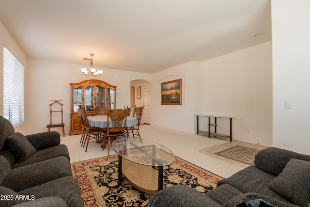 170 E Canary Ct, San Tan Valley, AZ 85143 - living area featuring arched walkways, a chandelier, and light colored carpet