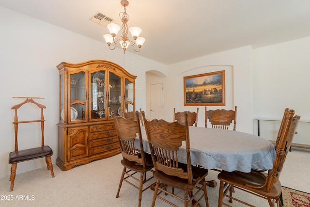 170 E Canary Ct, San Tan Valley, AZ 85143 - dining space featuring light colored carpet, a chandelier, and arched walkways