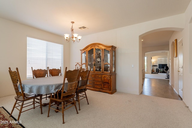 170 E Canary Ct, San Tan Valley, AZ 85143 - carpeted dining room featuring a chandelier and arched walkways