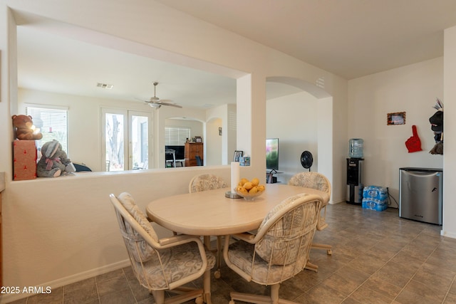 170 E Canary Ct, San Tan Valley, AZ 85143 - dining room featuring arched walkways, ceiling fan, and baseboards