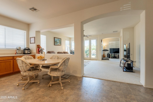 170 E Canary Ct, San Tan Valley, AZ 85143 - carpeted dining room featuring arched walkways, a ceiling fan, and baseboards