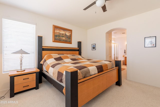170 E Canary Ct, San Tan Valley, AZ 85143 - bedroom featuring light colored carpet, arched walkways, ceiling fan, and connected bathroom