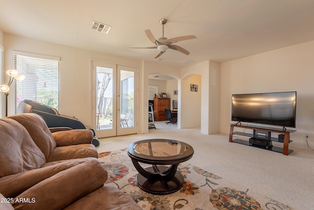 170 E Canary Ct, San Tan Valley, AZ 85143 - carpeted living area featuring arched walkways, ceiling fan, and french doors