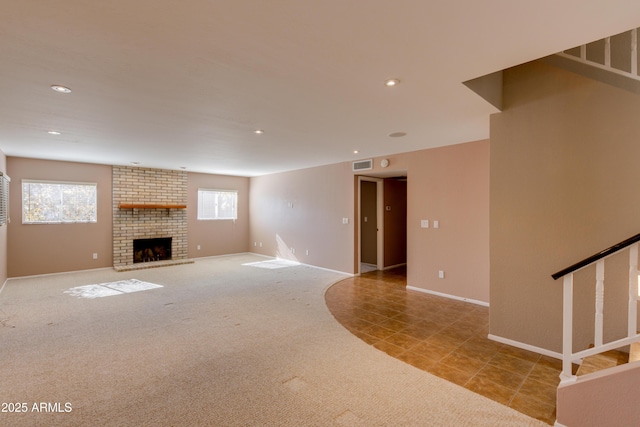 unfurnished living room with a fireplace and light colored carpet